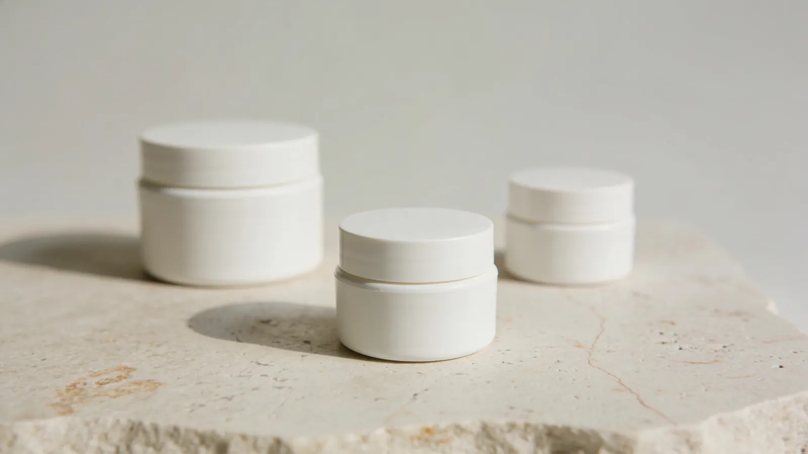 Three plain cream jars of different sizes
