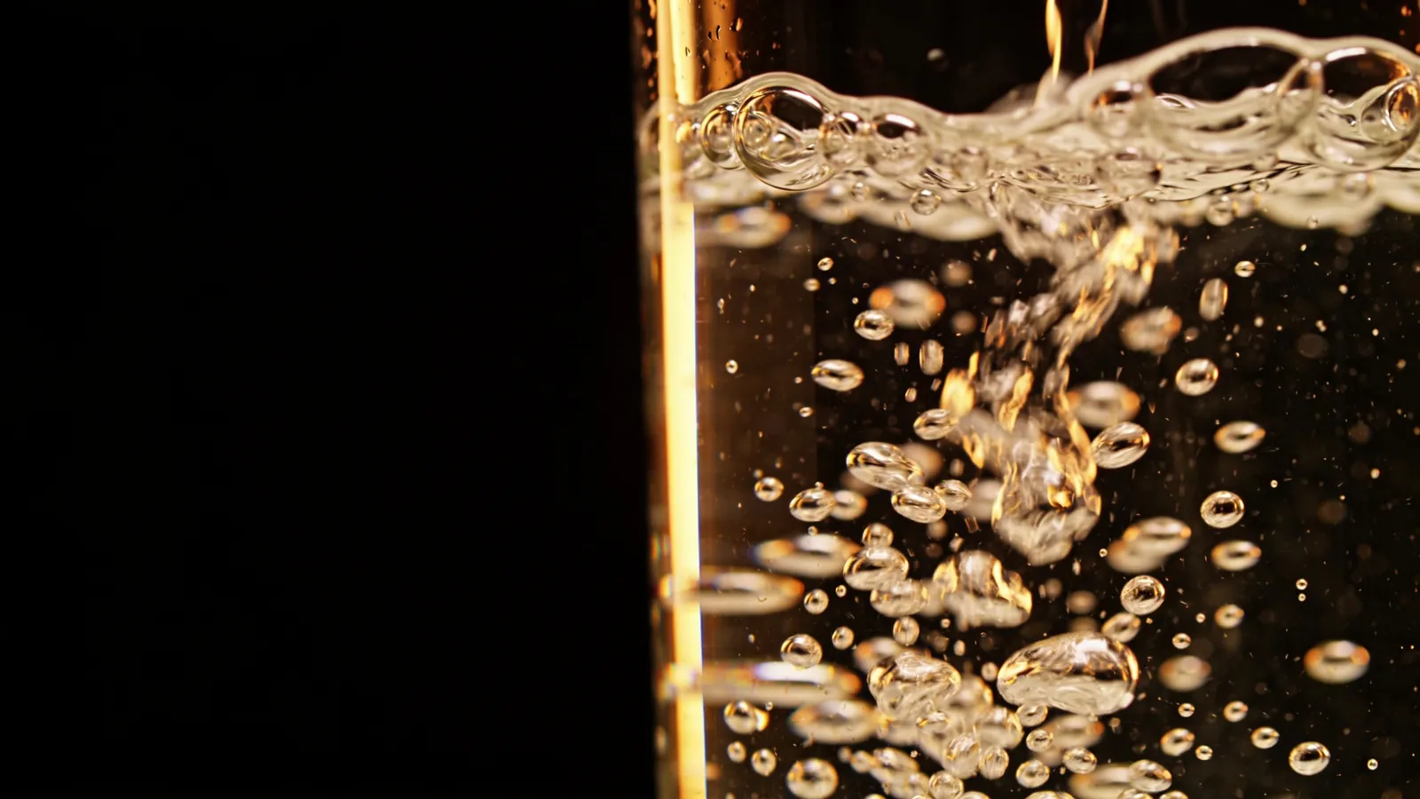 Tiny water bubbles swirling in a glass, illustrating water-based facials