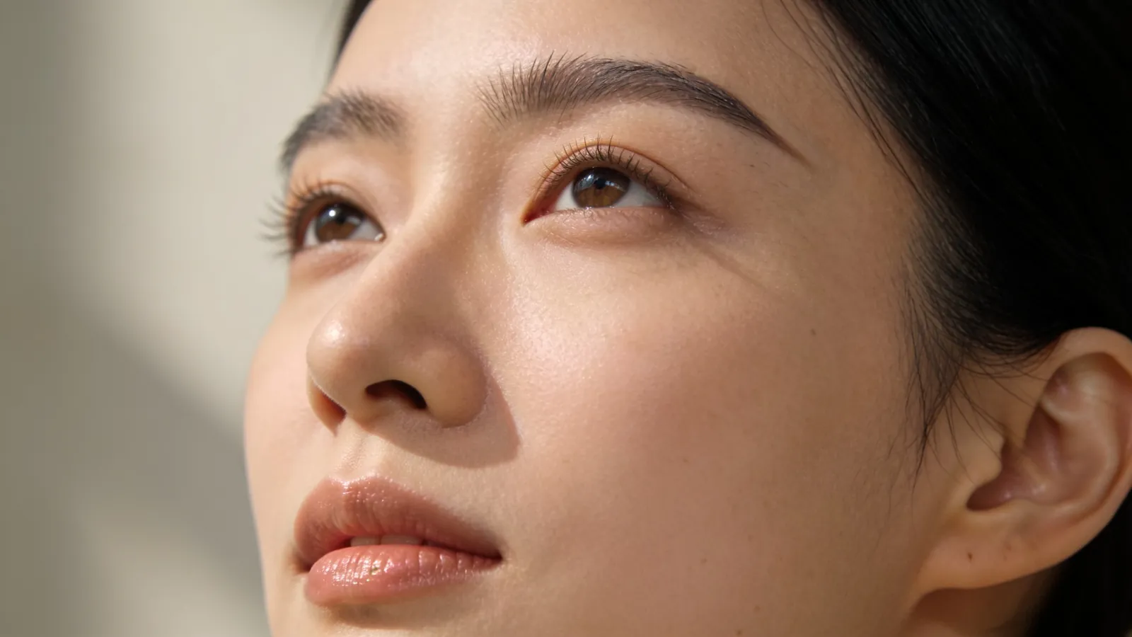 Woman with natural brows and relaxed eyes looking slightly up