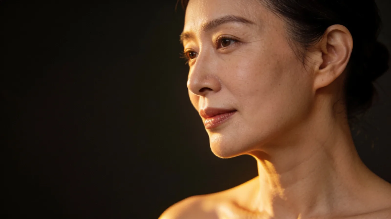 Woman in her forties in three-quarter profile showing a natural jawline
