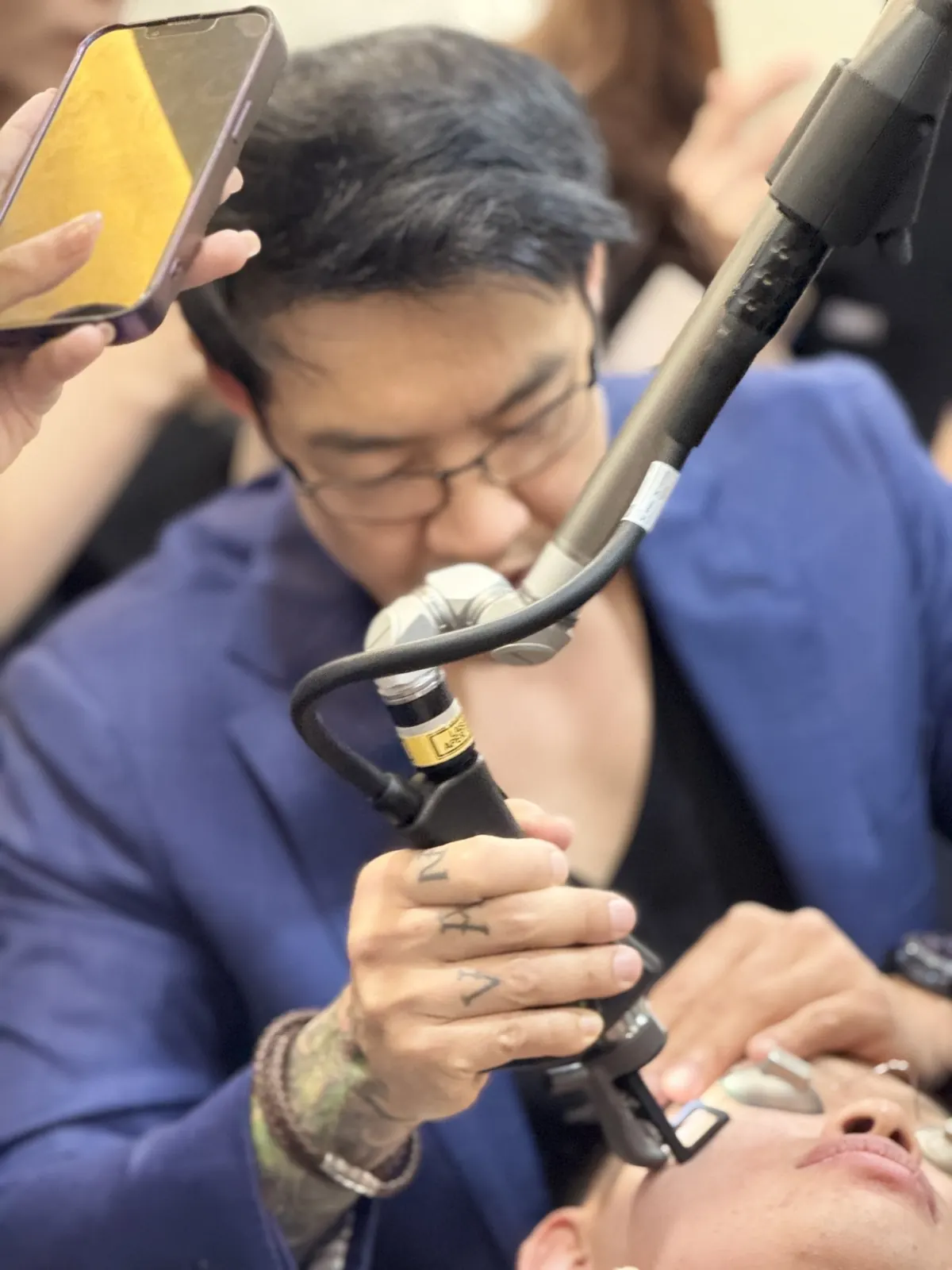 Dr Davin Lim treating Dr Sin Yong, the live demonstration patient